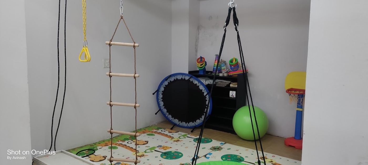 Sensory classroom with trapeze, trampoline and swing equipment